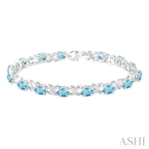 7x5  MM Oval Cut Blue Topaz and 1/20 Ctw Round Cut Diamond Fashion Bracelet in Sterling Silver