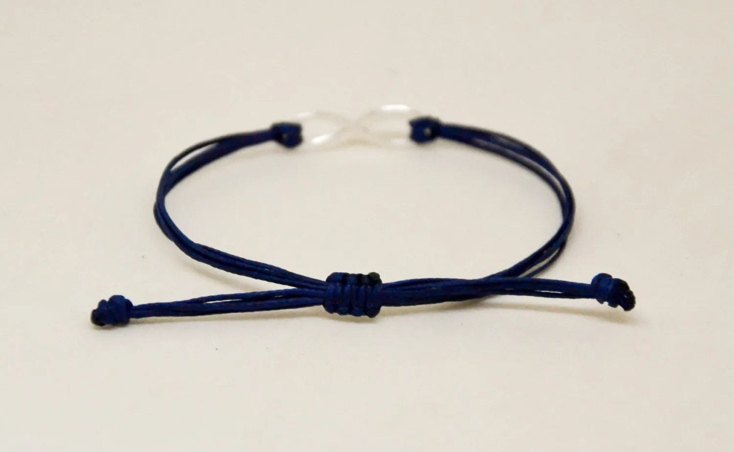 Adjustable silver infinity bracelet for men, blue cord, yoga jewelry