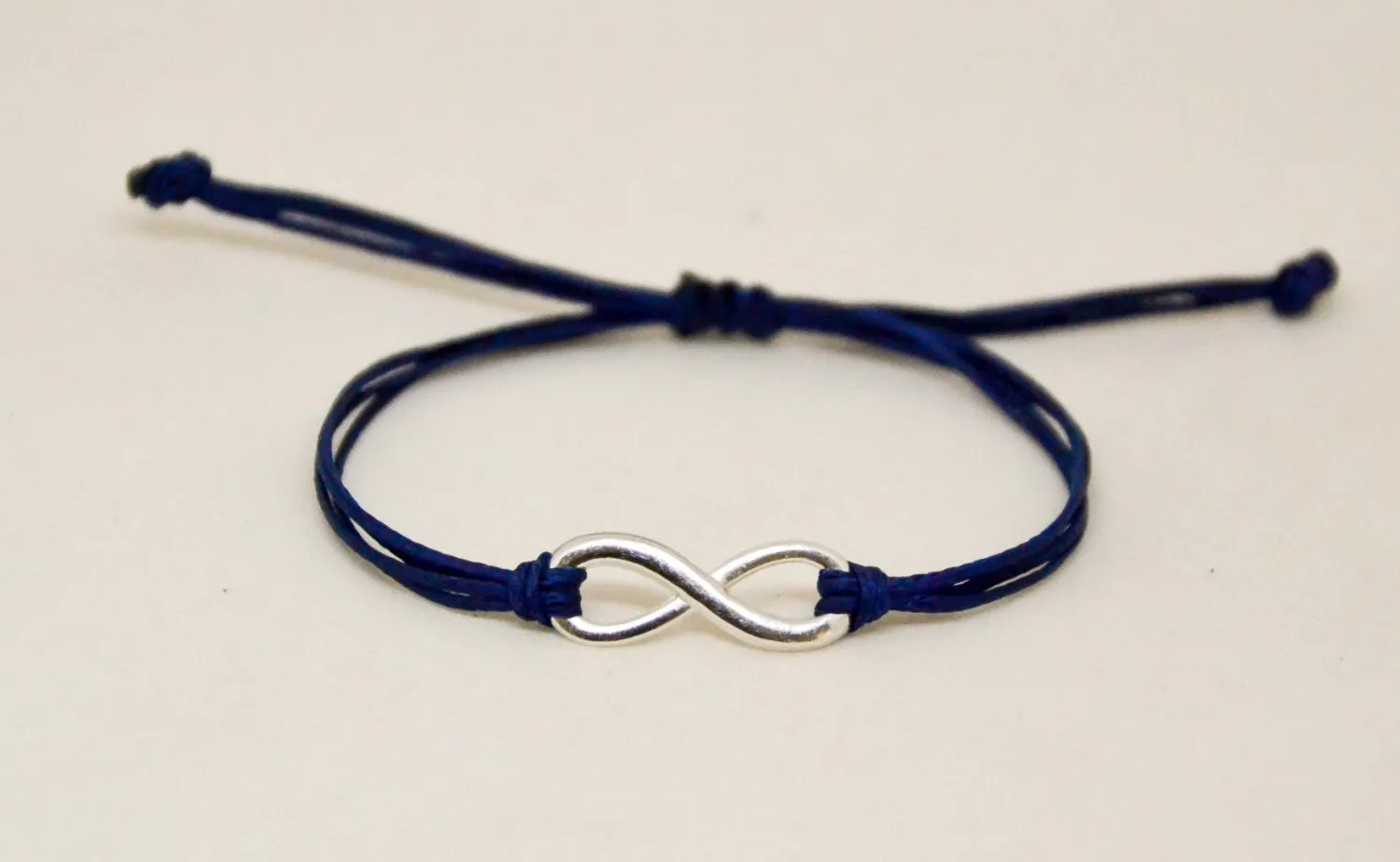 Adjustable silver infinity bracelet for men, blue cord, yoga jewelry